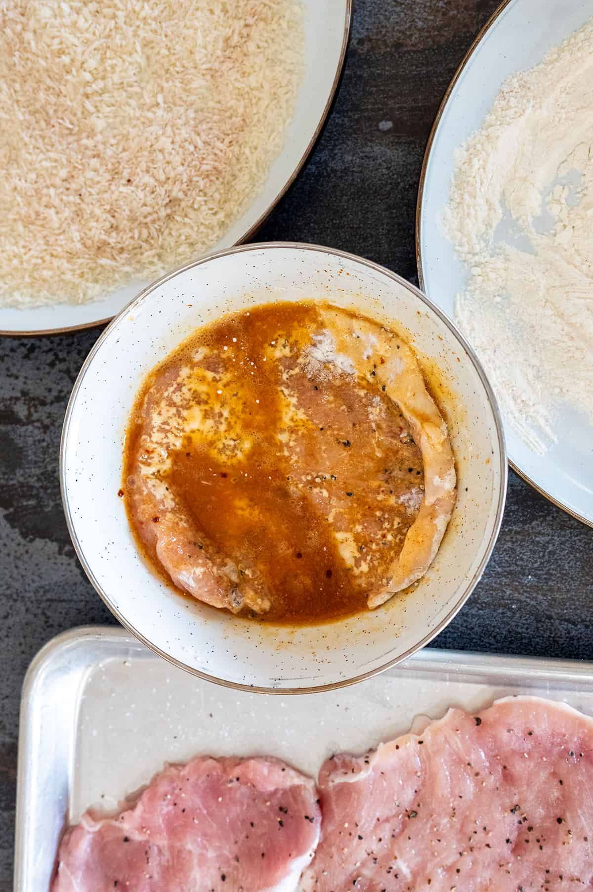 Pork cutlet in egg wash.