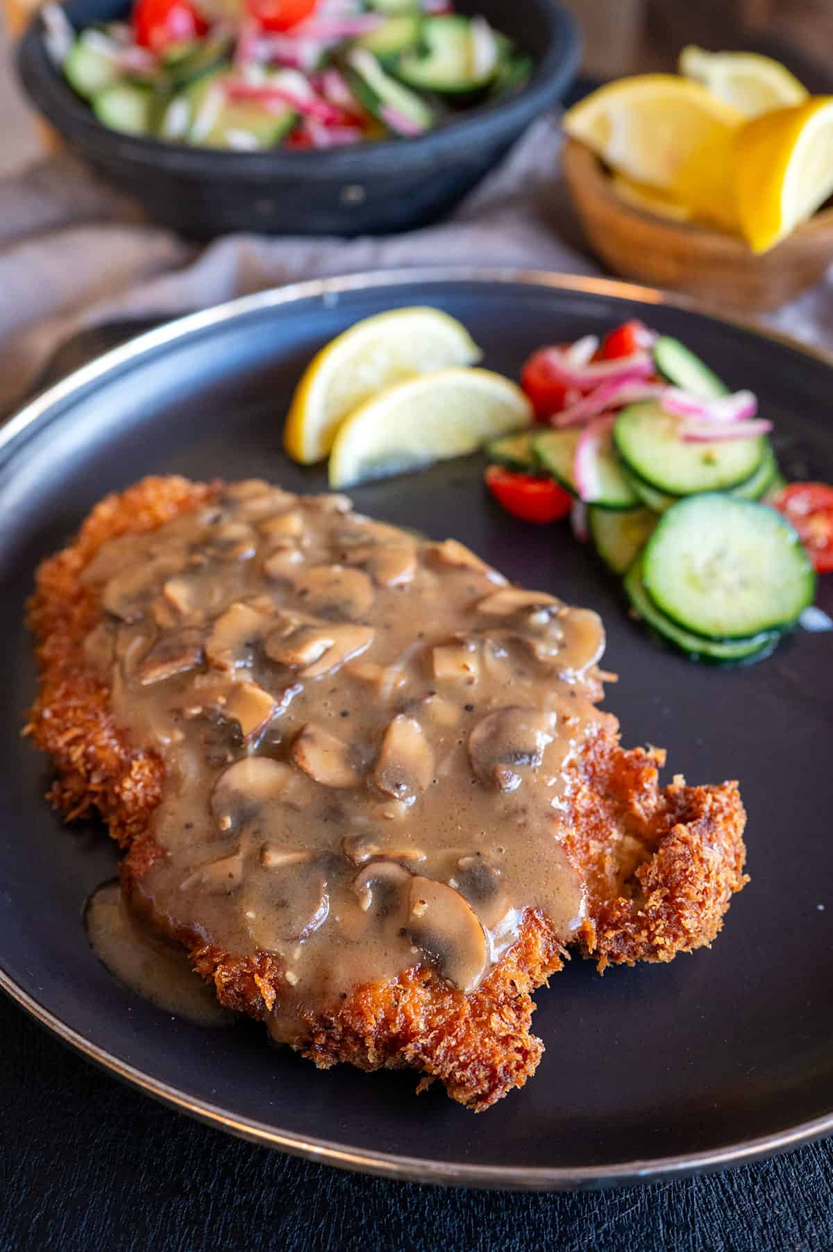 Plate of pork schnitzel with gravy.