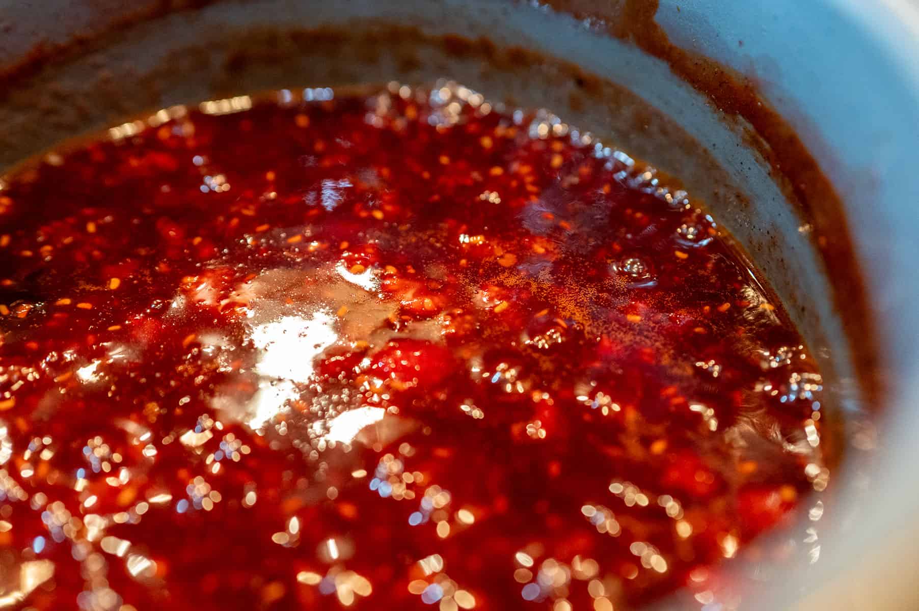 Raspberry Chipotle Sauce thickening in pot.