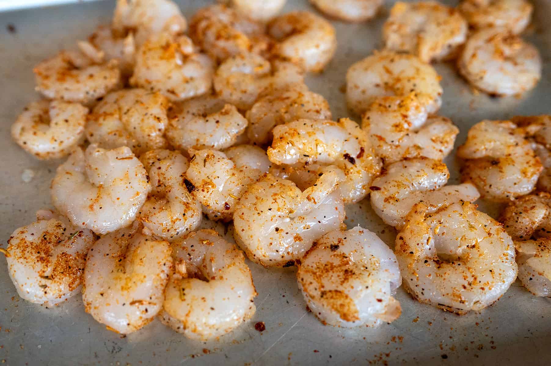 Seasoned shrimp on a pan.