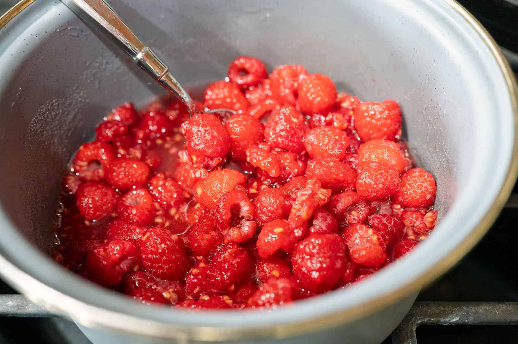 Simmering raspberries and sugar.