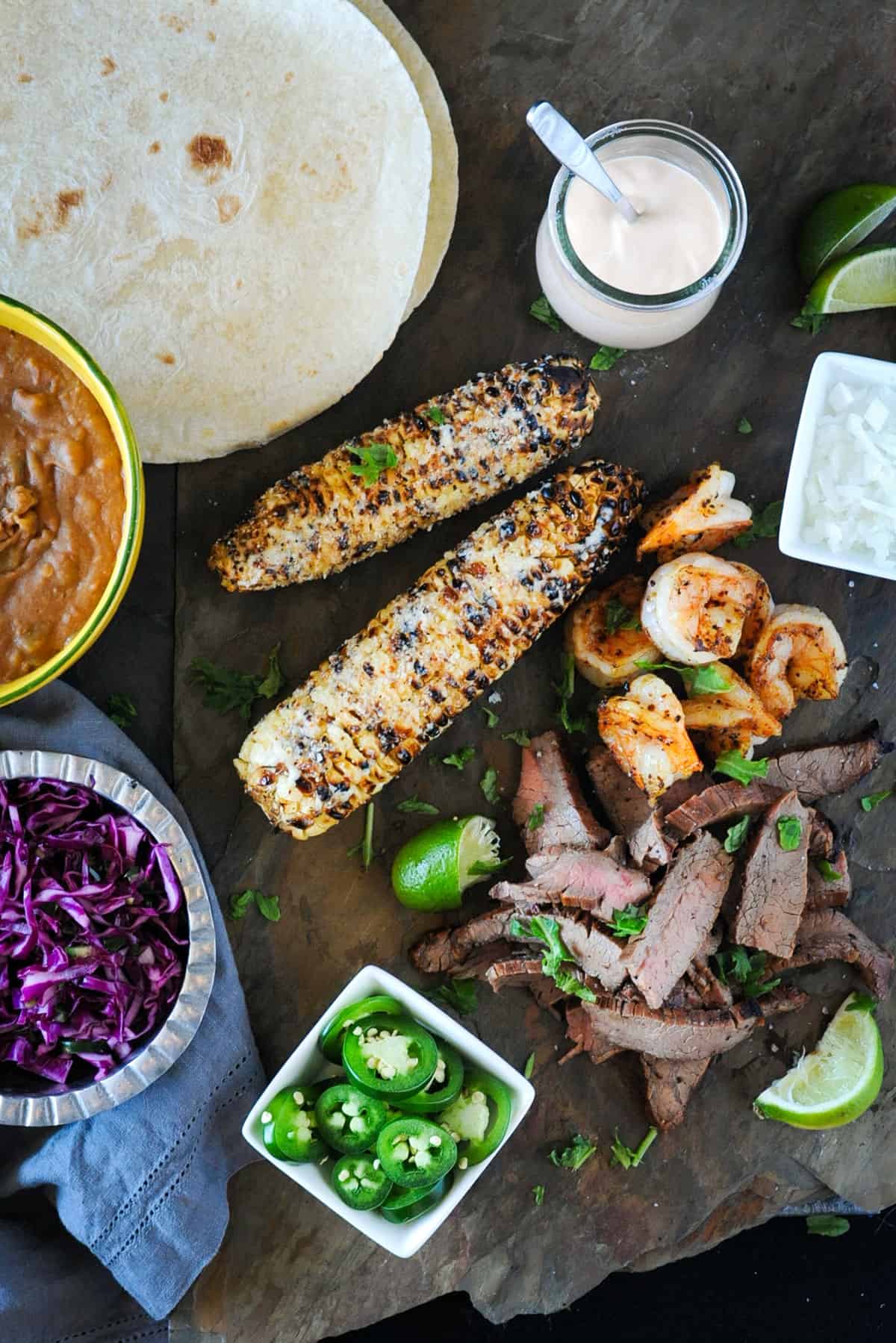 spread of grilled tacos and corn.