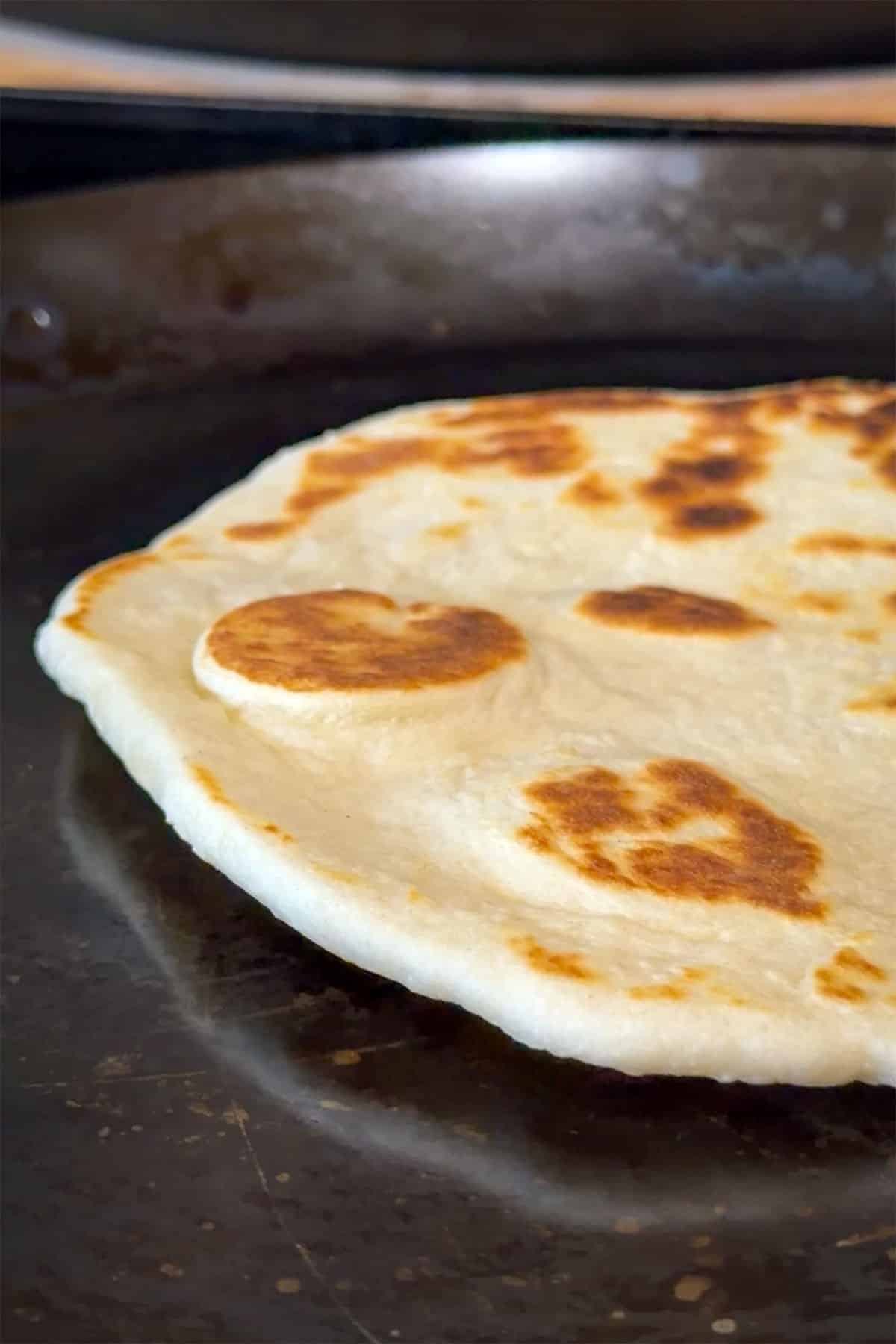 Perfectly thin flatbread cooking.