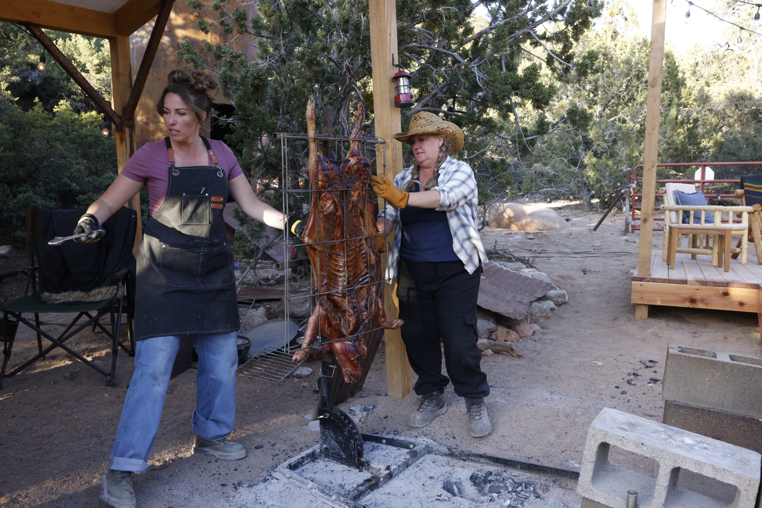 Susie and Christie cooking a whole hog.