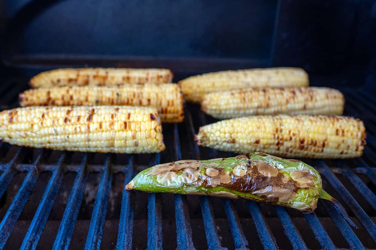 charred corn and green chile on grill.