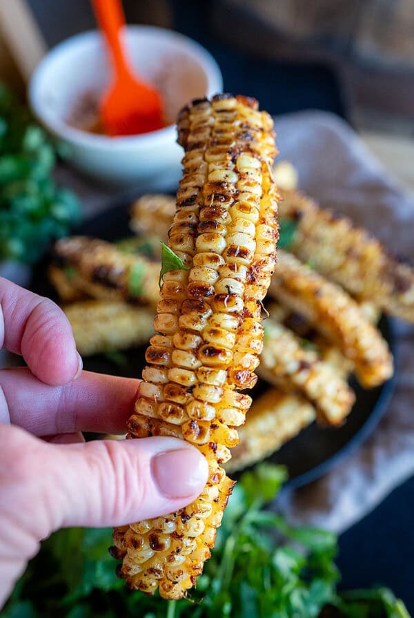Holding Grilled Corn Ribs.